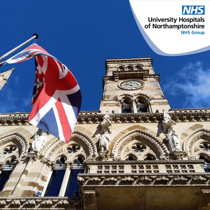 An ornate sandstone coloured building. The Union Flag is flying to the bottom  left of the photo. The sky is bright and blue.