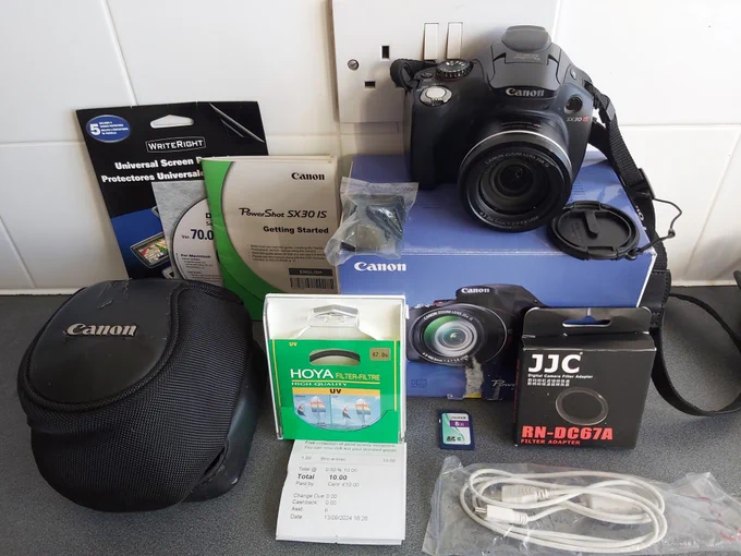 Photo of Canon PowerShot SX30 IS camera and accessories