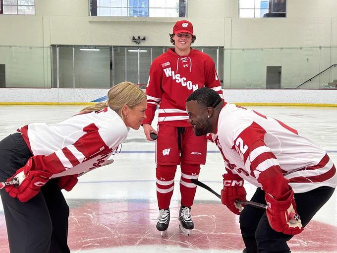 Jenny Taft and Mark Ingram take a face-off at center ice officiated by Owen Lindmark