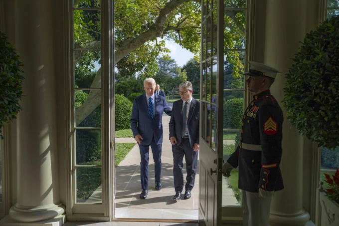 President Biden walks with U.K. Prime Minister Keir Starmer.