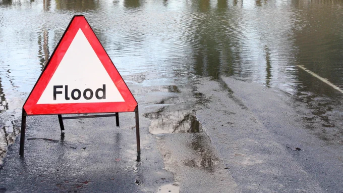 Flood sign on a flooded road