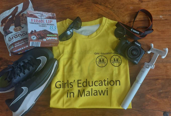Kiltwalk prep packing. Tee-shirt, camera, selfie stick, energy bars, trainers.