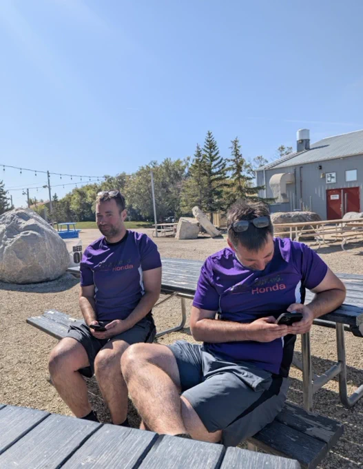 It’s me on a picnic table looking at the camera, beside me on a picnic bench looking at my phone