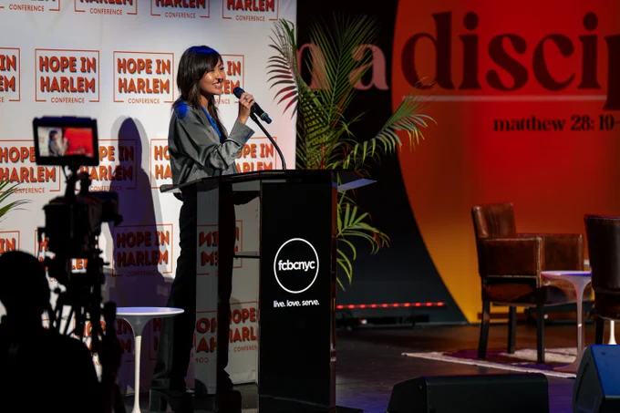 Student on stage at the Hope in Harlem Conference.