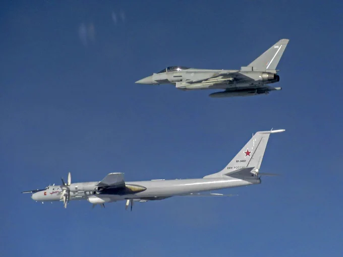 Image shows an RAF Typhoon flying next to a Russian aircraft during a QRA intercept.