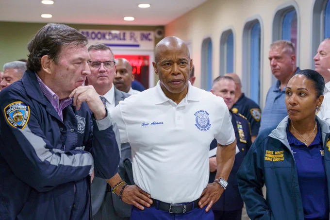 A photo of the mayor and others in NYPD gear standing inside.