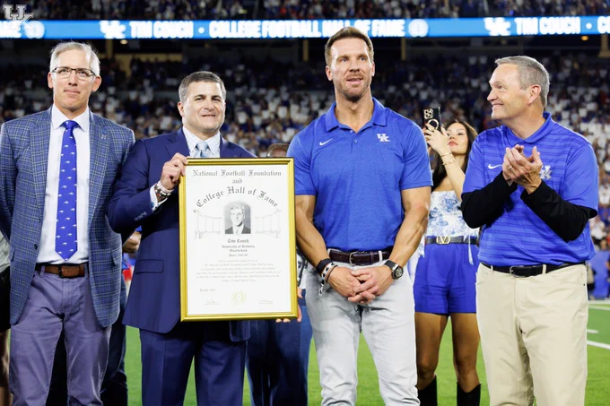 Tim Couch with the NFF and College Football Hall of Fame with the framed plaque. 