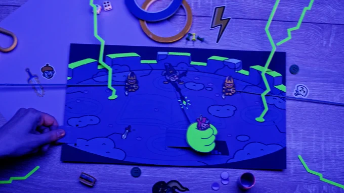 Screenshot from The Plucky Squire papercraft trailer as Humgrump causes Jot a spot of bother