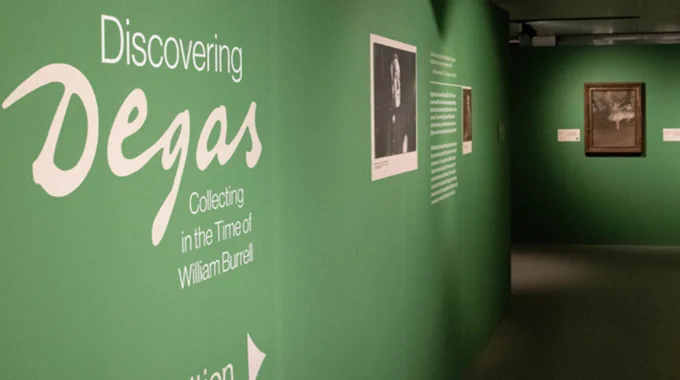 A green wall with the words Discovering Degas, Collecting in the Time of William Burrell, written across it.