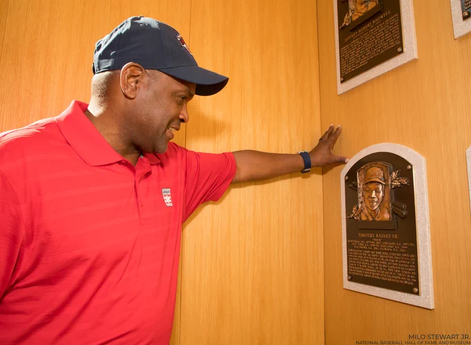 Tim Raines admires his Hall of Fame plaque on the wall of the Plaque Gallery. (Milo Stewart Jr./National Baseball Hall of Fame and Museum)