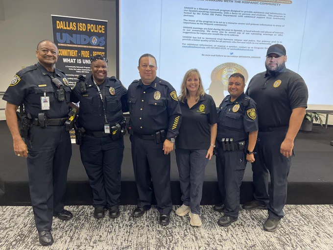 Deputy Chief James Smith and Lt. Gregg getting a picture with Dallas ISD Chief Albert Martinez and team.