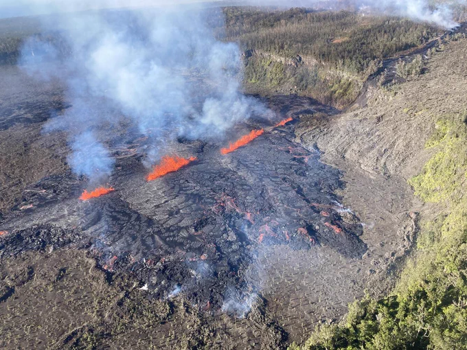 This photograph of Kīlauea's ongoing middle East Rift Zone eruption was captured during a Hawaiian Volcano Observatory helicopter overflight during the morning of September 17, 2024. Geologists observed fountaining eruptive fissures and active lava flows on the floor of Nāpau Crater, just downrift (northeast) of the September 15 eruptive fissure. This south-facing view shows the current activity from the north side of Nāpau Crater. USGS photo by A. Ellis.