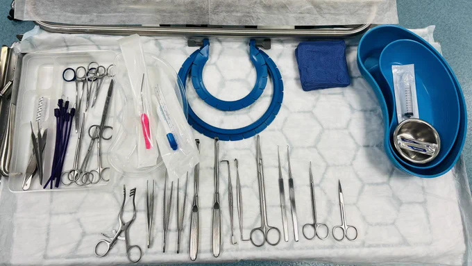 A tray of surgical instruments layed out on a table ready for the surgical education course.