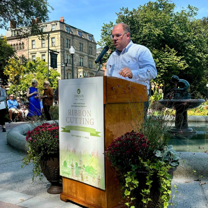 Parks Commissioner Ryan Woods makes remarks in front of the restored fountain project. 