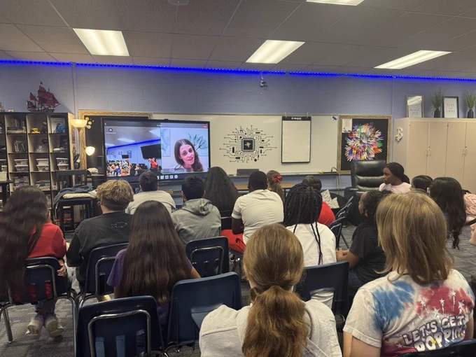 Students watching Jordyn on the interactive board.