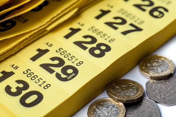 A close up image of a yellow raffle ticket