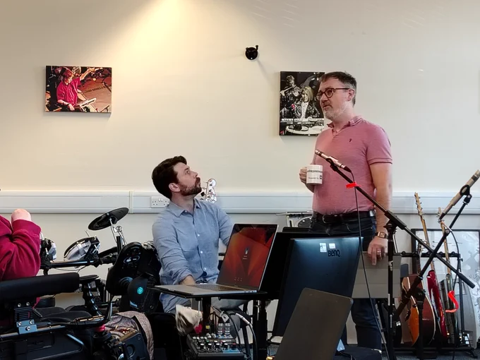 Colin looking up at Stuart who is giving him a lesson in Scots Gaelic