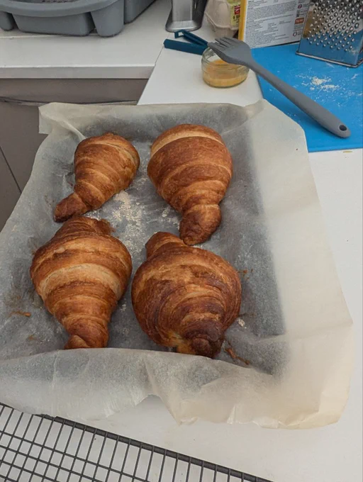 Cooked croissants on a baking tray