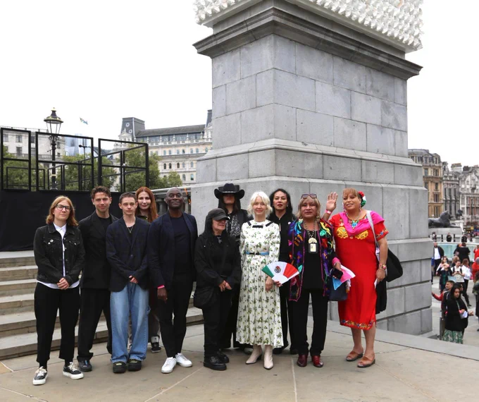 A group of people standing by the Fourth Plinth.