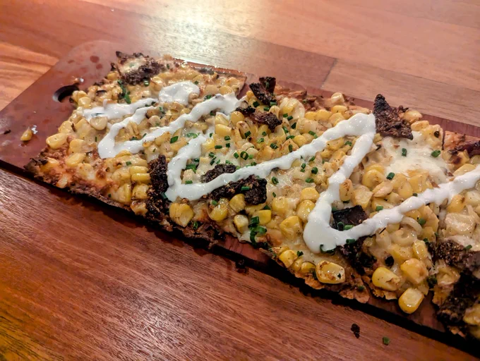 Bacon, corn and cheese on flatbread