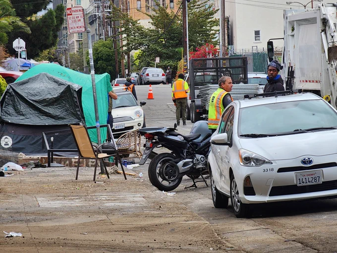 Oakland DOT staff speak with camp residents on Wednesday, September 18, 2024.
