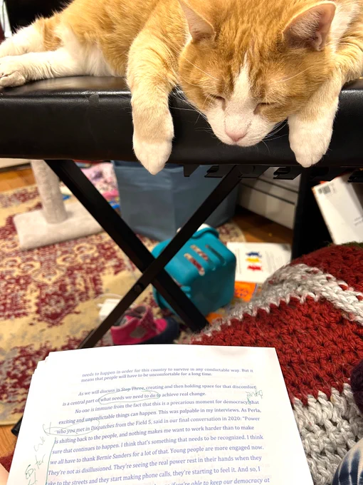 Orange and white cat sleeping on a keyboard-style piano with head and paws drooping over the edge, making it look like it's observing a printed page with edits made by hand.