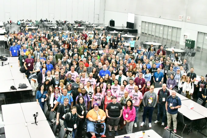 An overhead view of the massive Contributor Day crowd smiling at the camera.