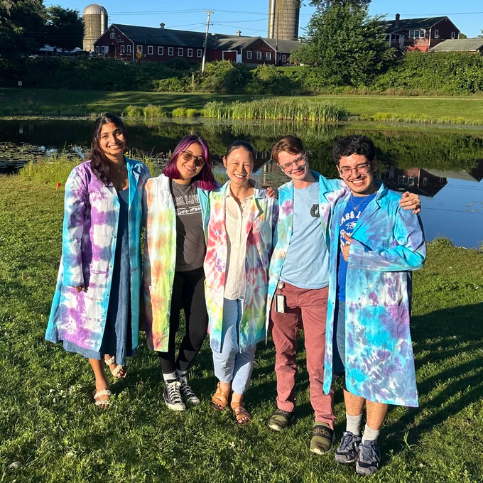 Five paper coauthors wearing tie-dye lab coats!
