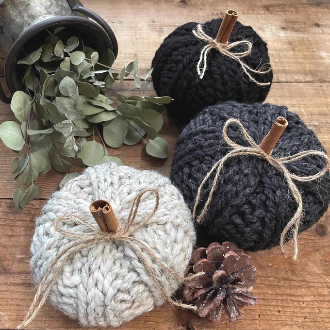 handmade knit pumpkins lying on a wooden surface 