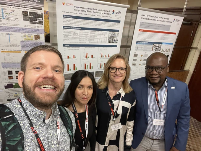 (From left to right) Mirco Kröll, Natalia Cano Murillo, Géraldine Theiler and Andreas Sheuyange Namwoonde standing in front of the two posters of BAM at PolyTrib. 