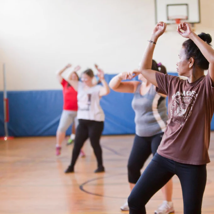 A room of people taking part in a fitness class