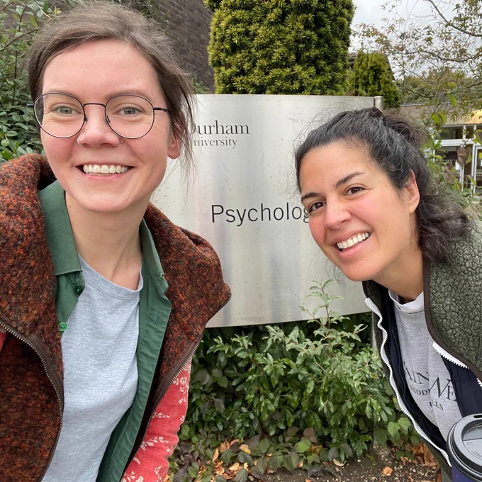 smiley selfie with Sheina Lew-Levy in front of the Durham University Department of Psychology building sign