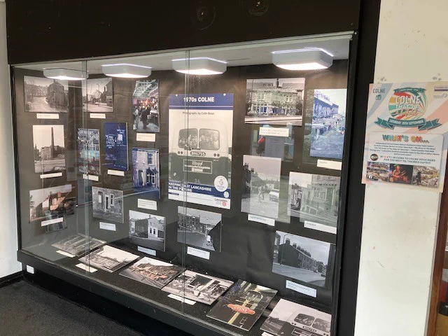 Exhibition case showing Colin Bean's photographs from Colne in the 1970s 