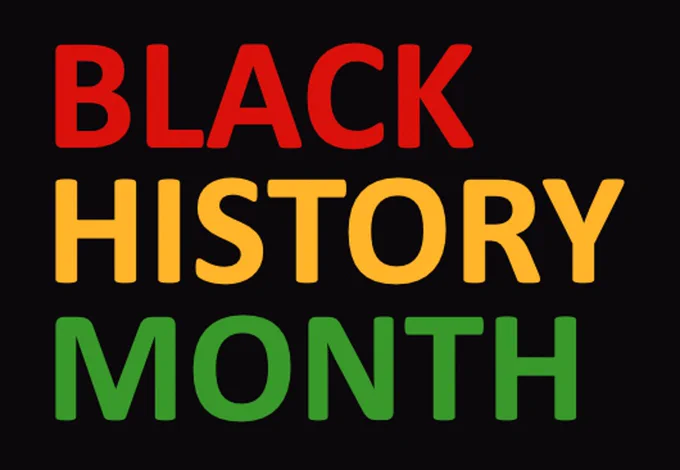 A black rectangular banner with the words Black History Month written on in different colours, red, gold and green.
