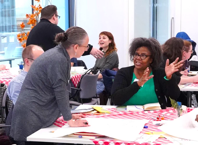 UNISON members discussing a course activity on tables during a training session