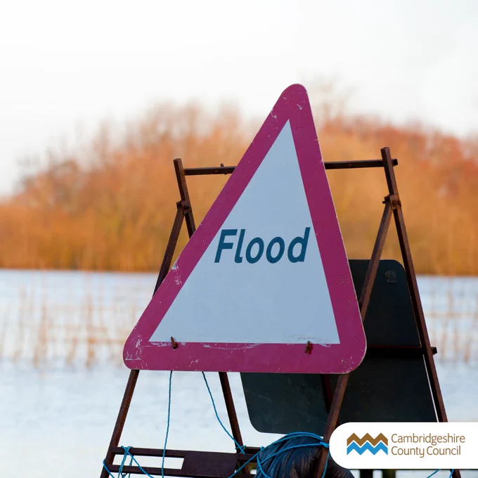 A flood sign on flooded land