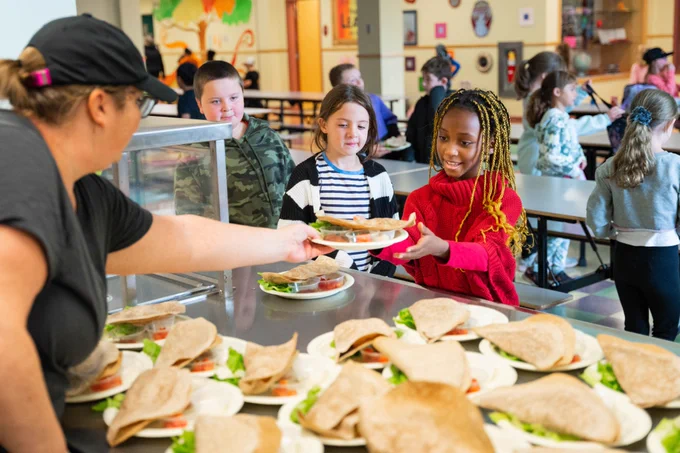 Students pick up their taco lunch orders in the cafeteria at St. Anne's elementary school in Glace Bay. 