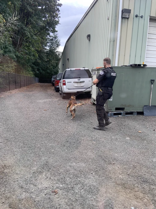 Police officer and his K-9 partner outside the DES Surplus building during a training.