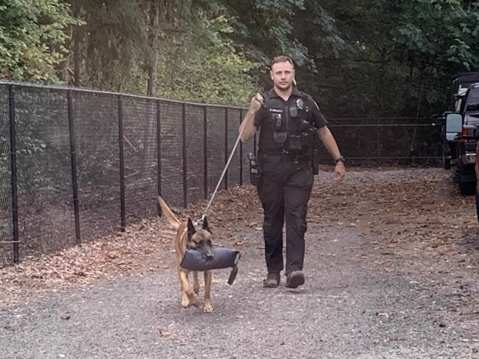 Police officer and his K-9 partner outside the DES Surplus building during a training.