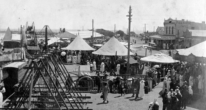 black and white photo of people mingling outdoors amongst tents