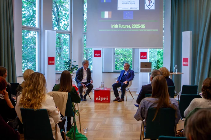 SIPRI event.
Dan Smith and Brendan O'Leary seated in the middle, full audience in the venue pictured on the sides. 