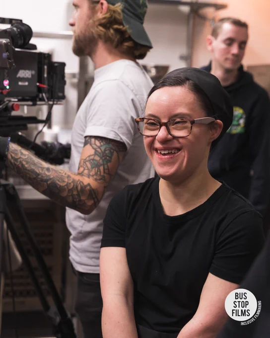 Woman on set with chef hat 