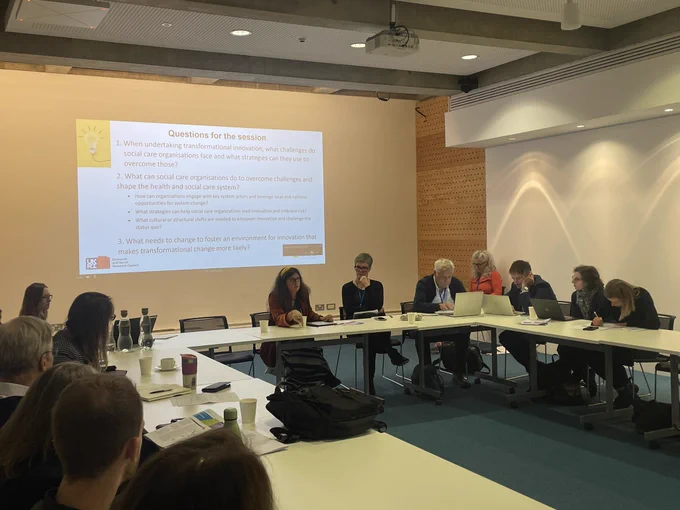 Photo of Emma and panellists talking about care innovation