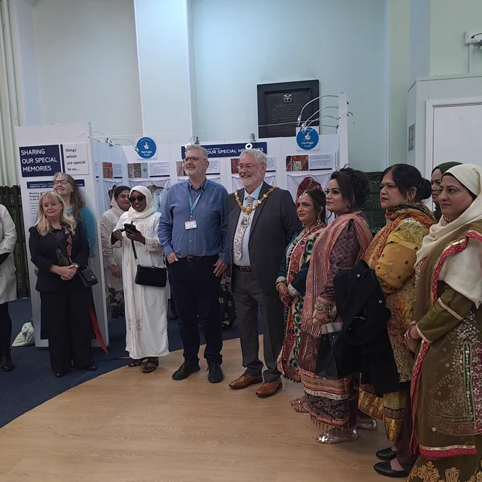 The Mayor, an archivist and key people involved in making the exhibition posing in front of the exhibition boards 