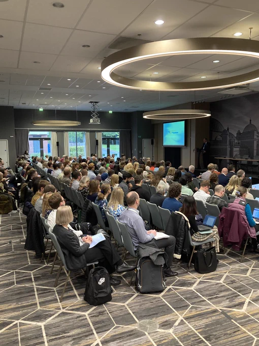 Around 200 people sat down in large conference room listening to a person speaking about air quality