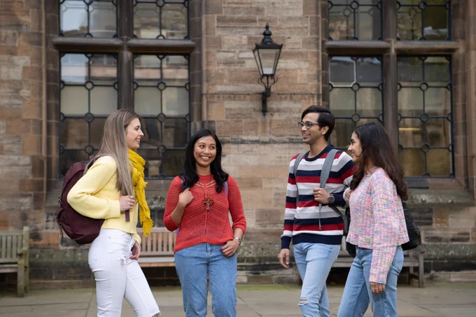 Group of four students in the east quad  
