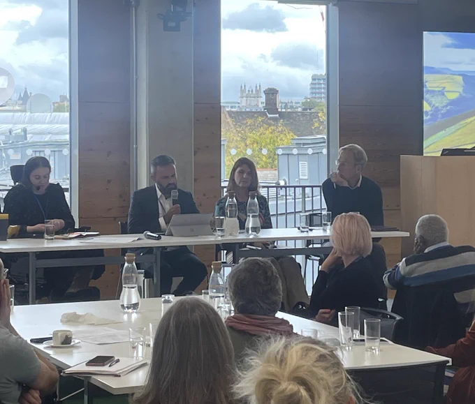 Photo of panellists speaking at the event