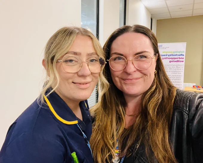 2 people smiling at the camera