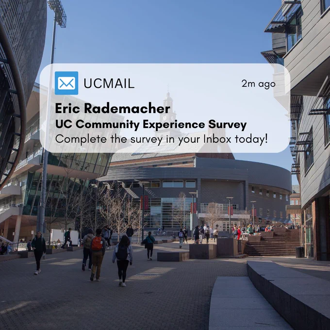 Email notification message that reads "UC mail from Eric Rademacher UC Community Experience Survey Complete the survey in your inbox today!" with background image of the University of Cincinnati's Main Street facing Nippert Stadium suites, Tangeman University Center, and Steger Student Life Center bustling with students