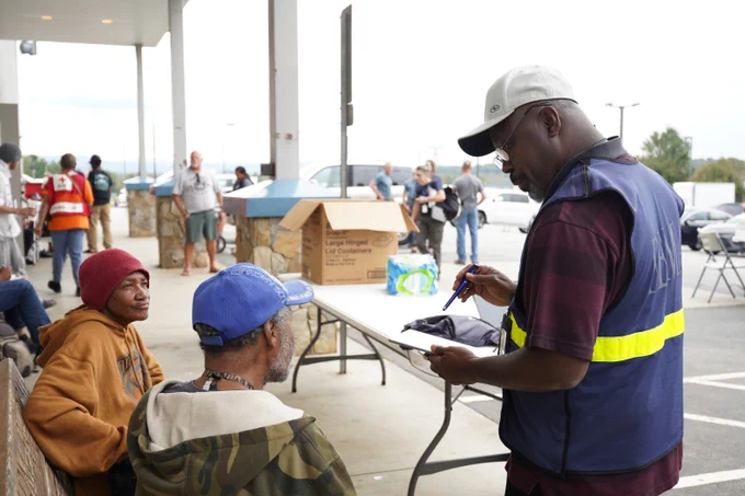 FEMA staff member helping people register for disaster assistance 